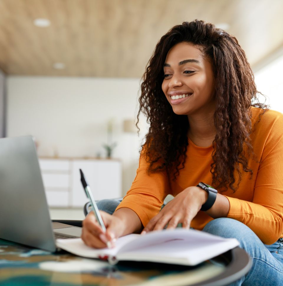 Young woman studying with notebook and laptop